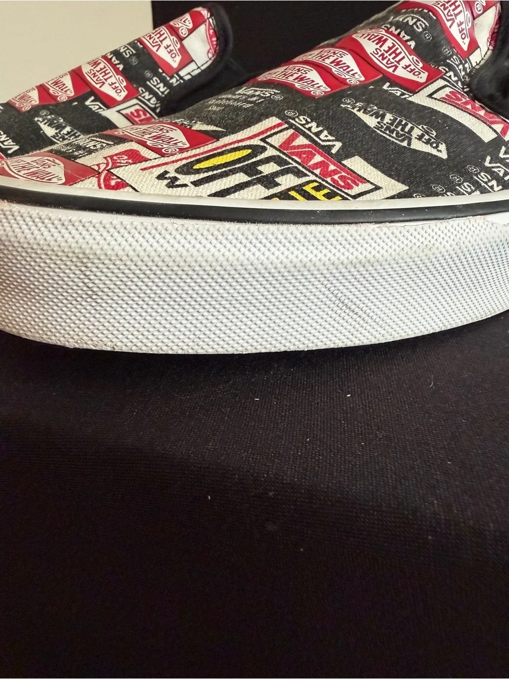 Vans Slip-On Sneakers in Black, White & Red Logo Print